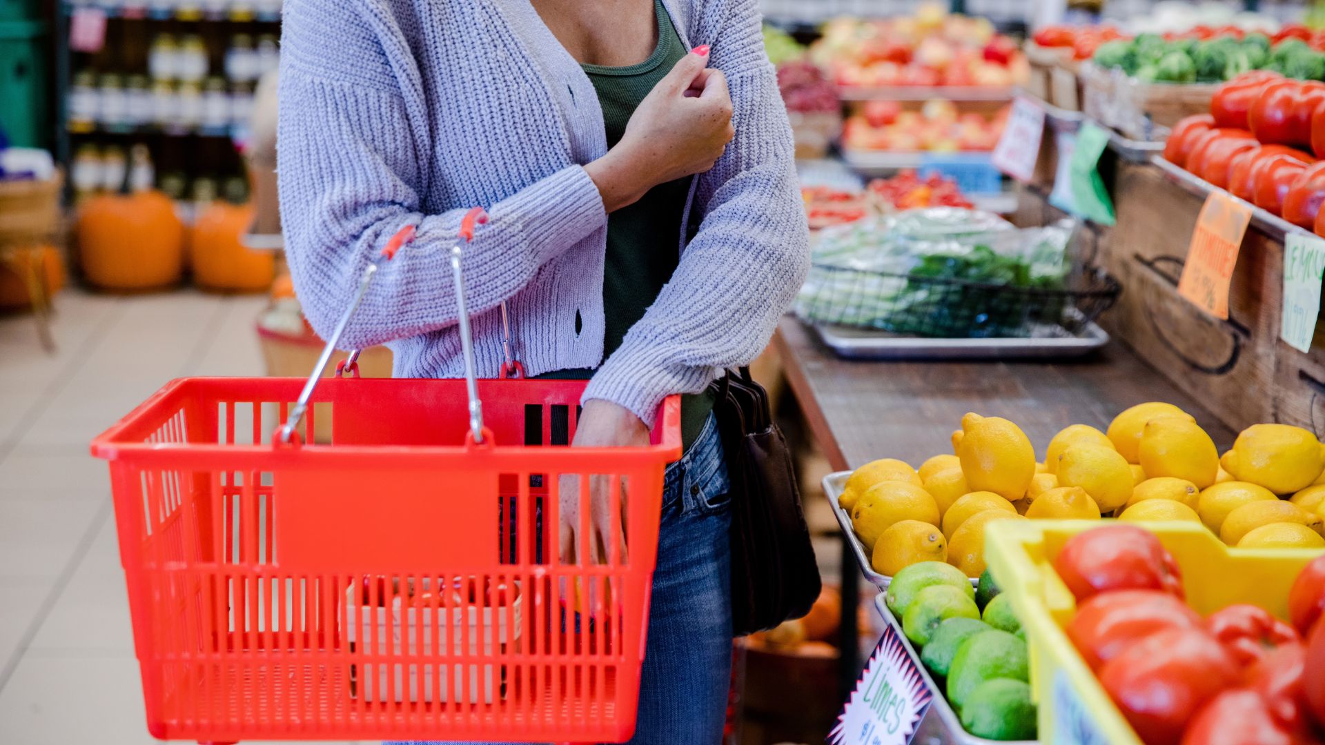 Image of a lady packing fruit in a grocery basket